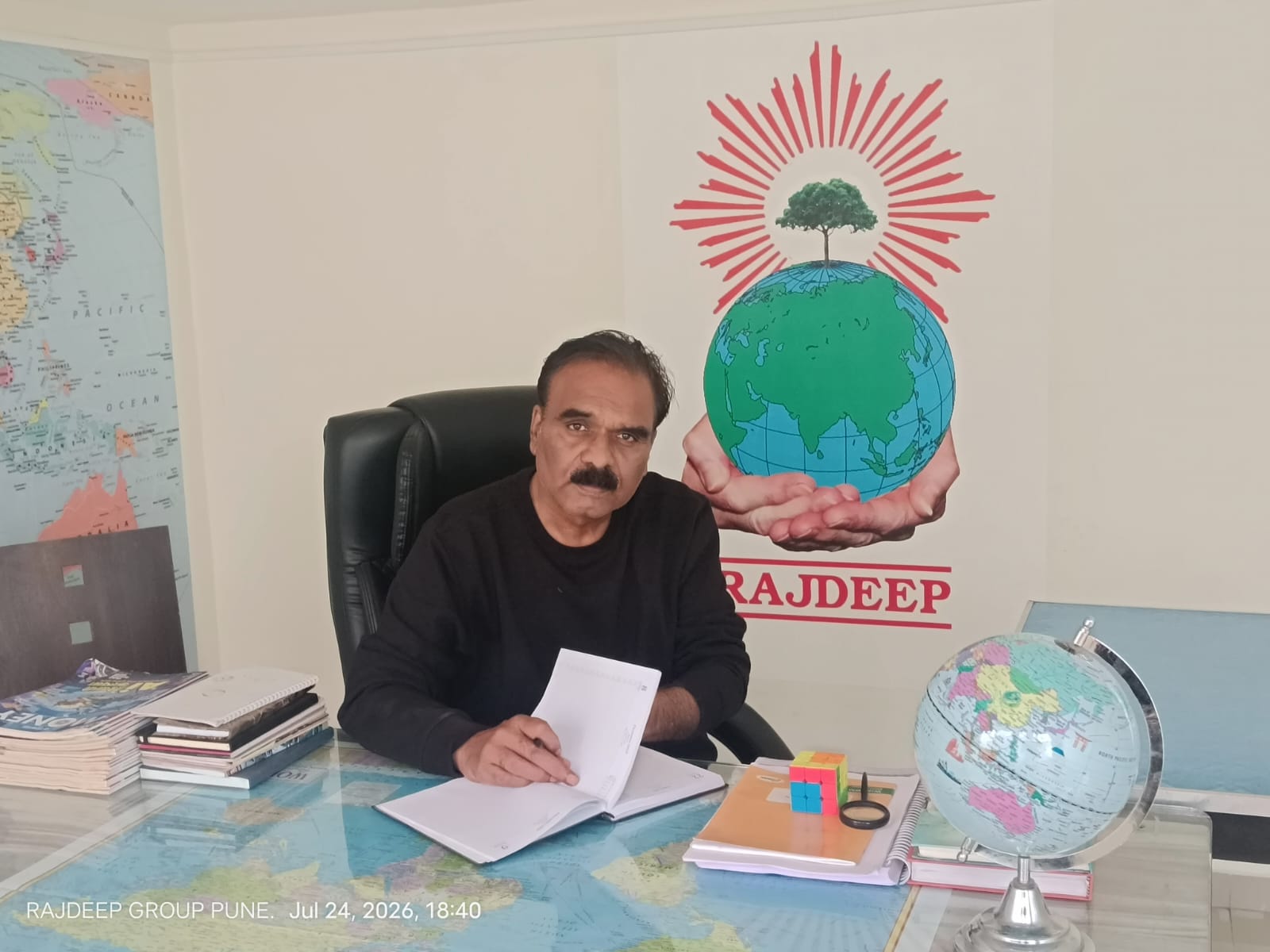 Rajdeep Group Pune office with global maps and brand mark