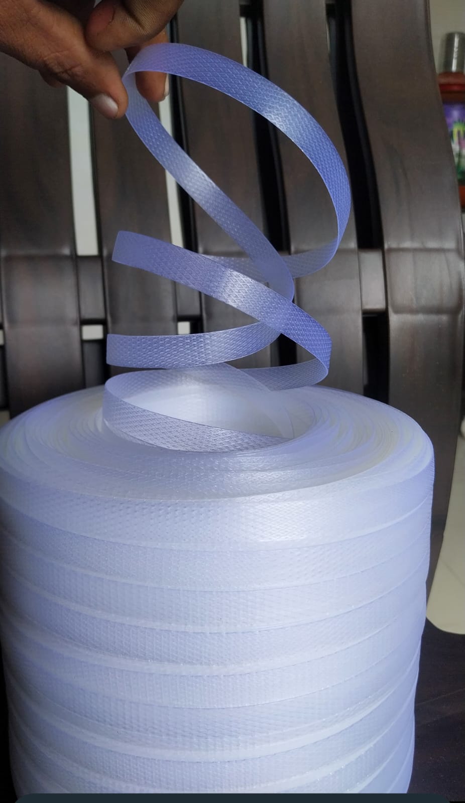 Textured plastic strapping roll